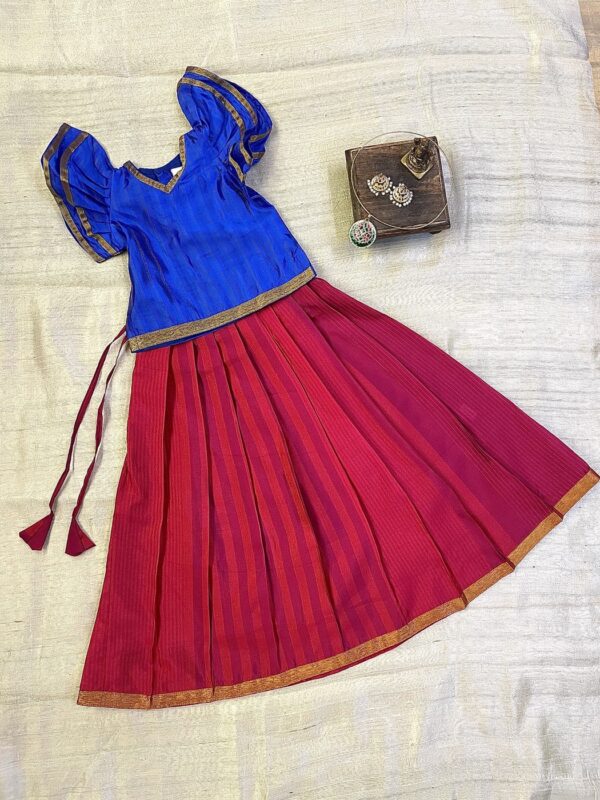 Traditional Attire and timeless charm in this blue and red pavadai sattai for girls