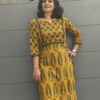 Girl wearing ajrakh yellow kurta posing before leaving for office
