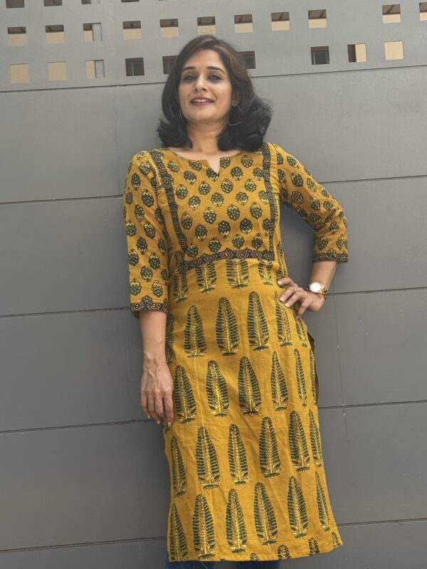 Girl wearing ajrakh yellow kurta posing before leaving for office