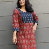 Red ajrakh kurta with contrast blue yoke in hand-embroidery for festive season
